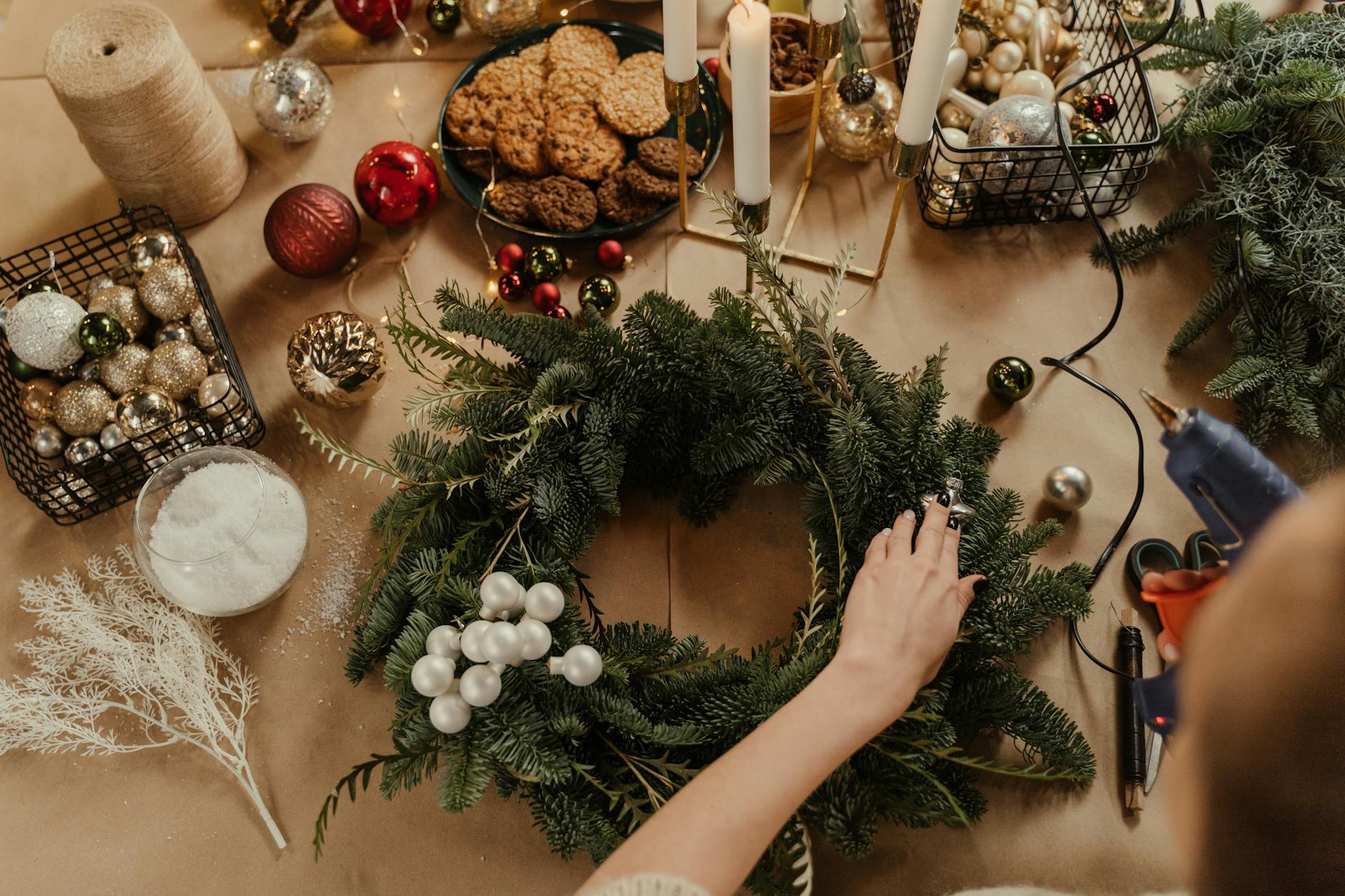 a hand holding the christmas decoration on the table