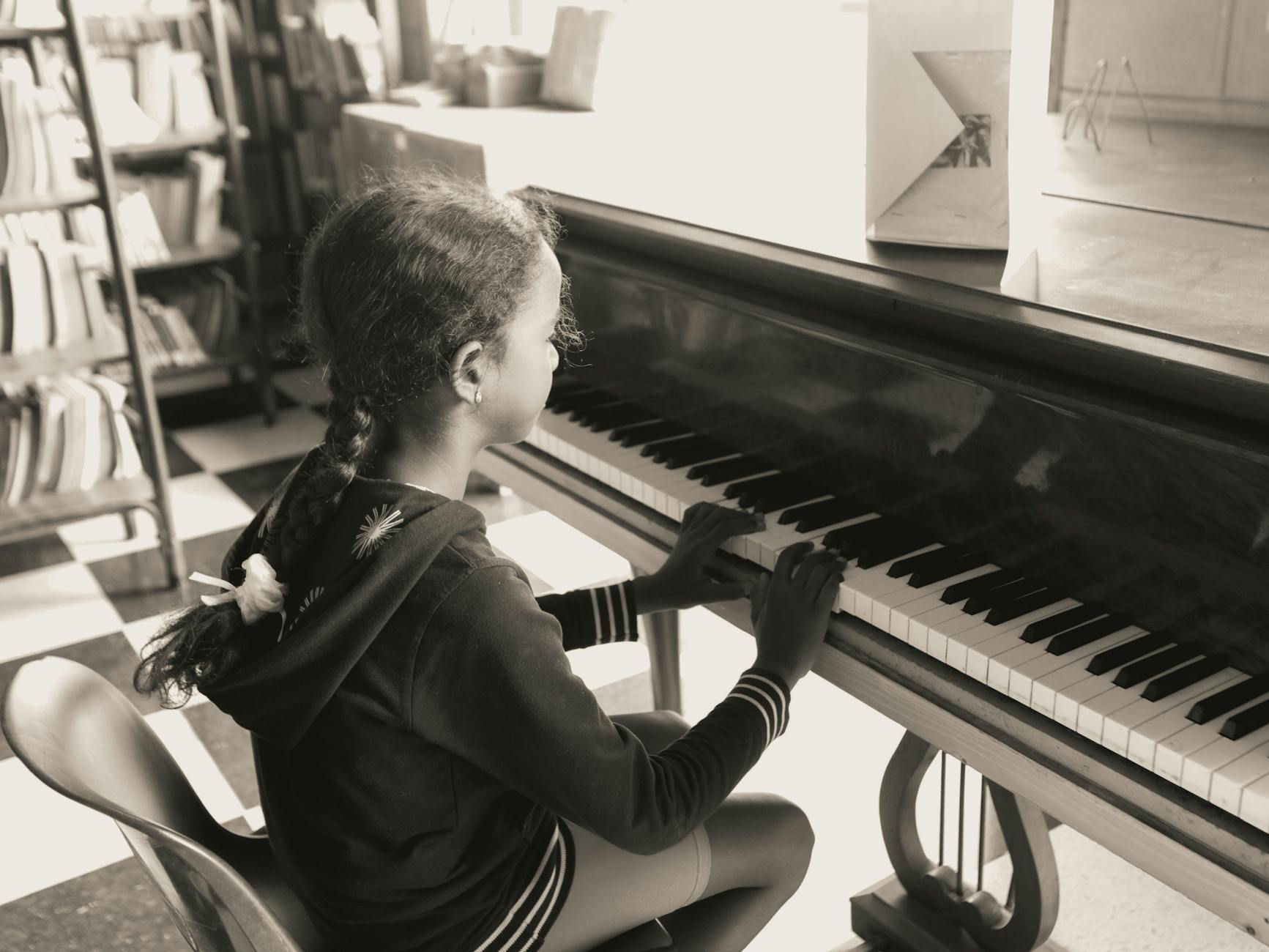 young girl playing on piano