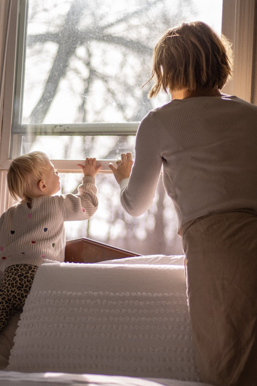 mother and child enjoying natural light indoors