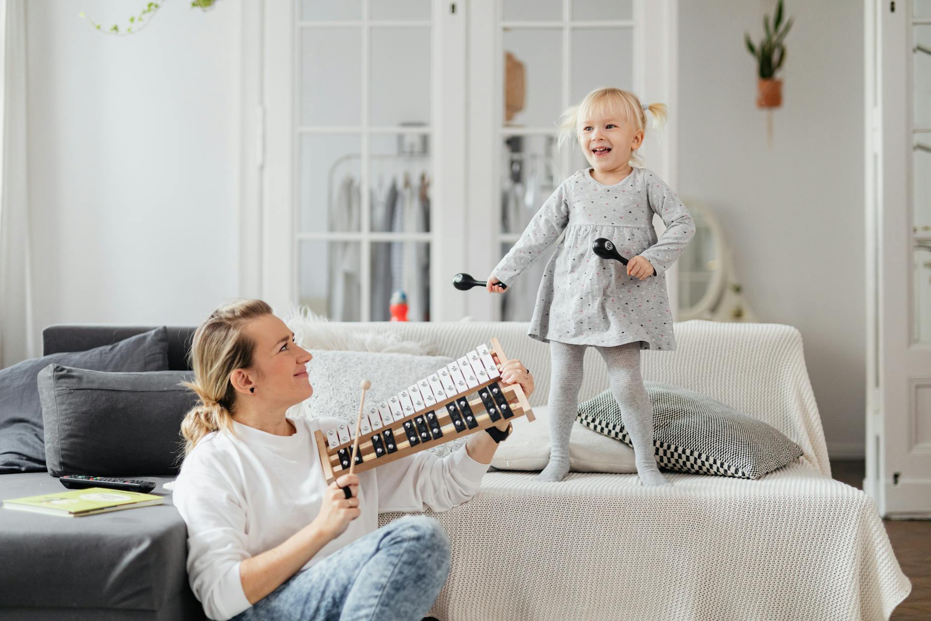 woman playing with daughter in living room