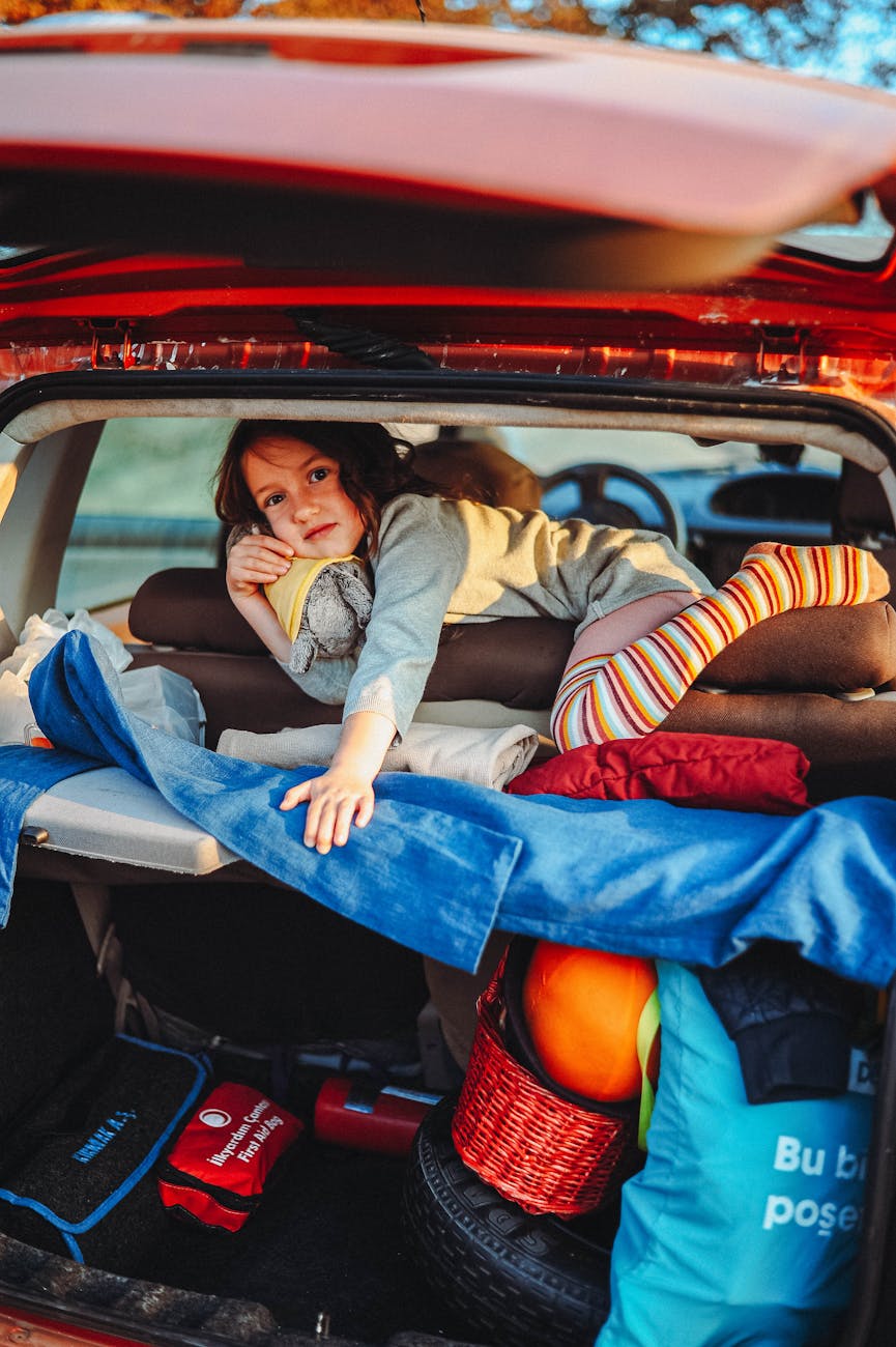 girl lying down in car trunk