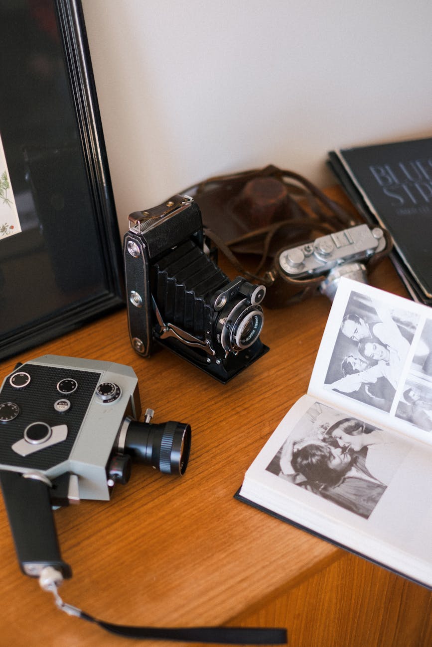 collection of vintage cameras on wooden cabinet