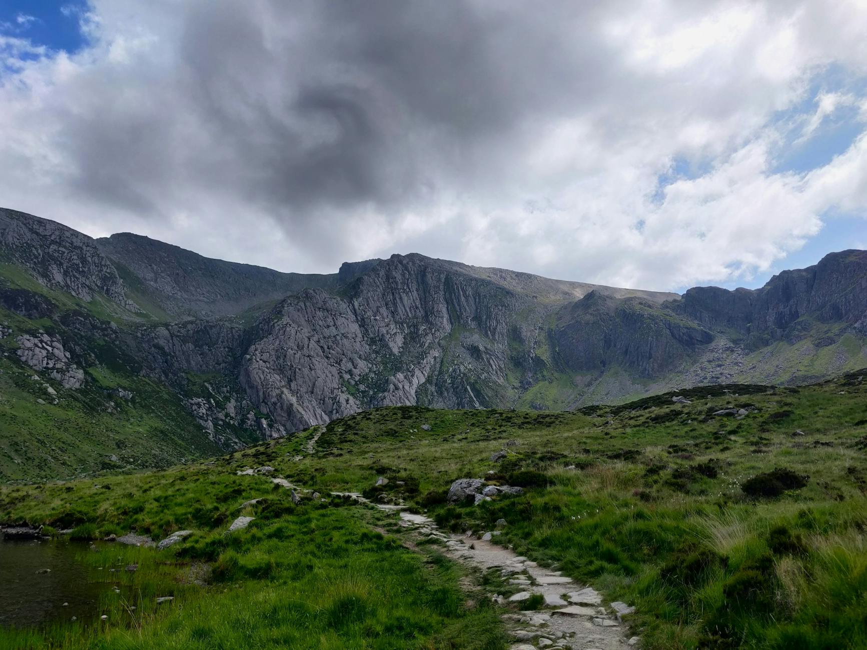 clouds over rocks on hills