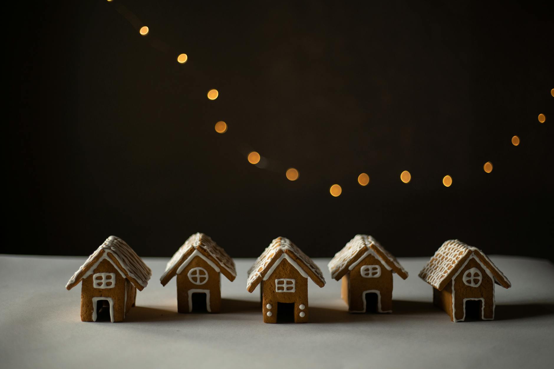 gingerbread houses lined up on white surface