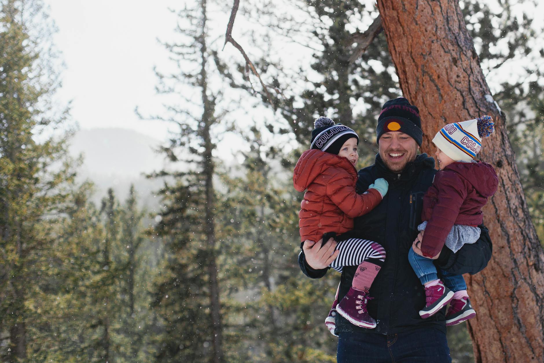 man lifting toddlers