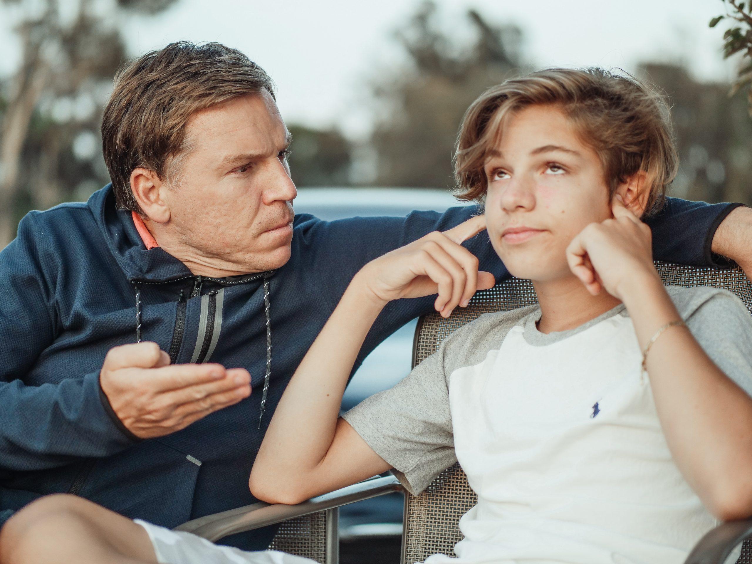 Man and young boy having a debate