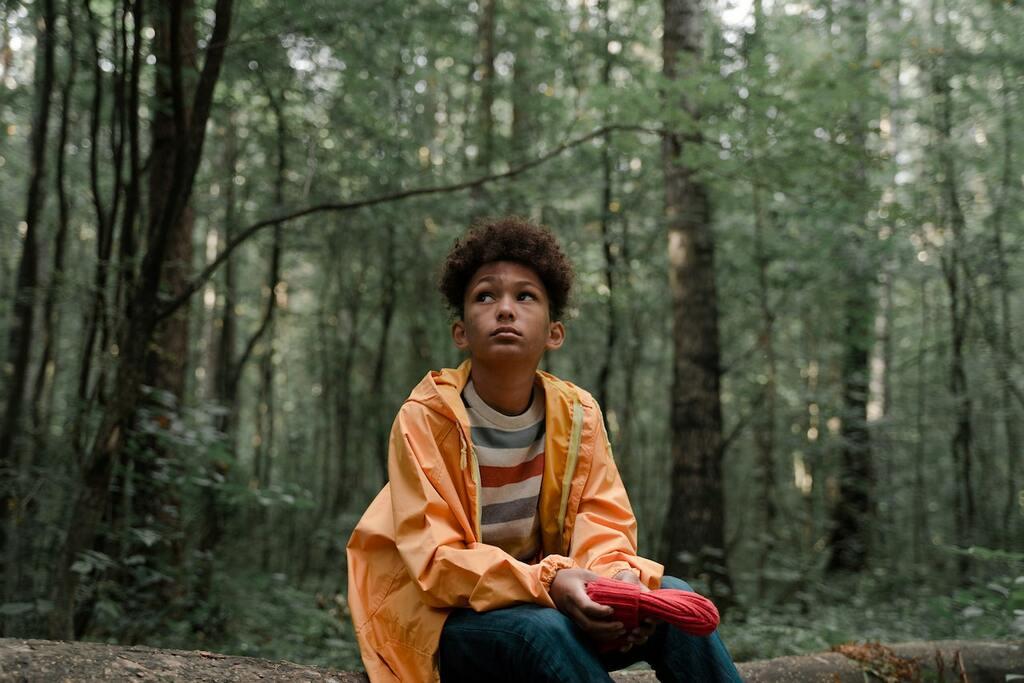an anxious child in a forest