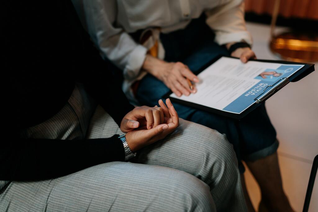 Person in black Long Sleeve Shirt Holding a Clipboard with Resume
