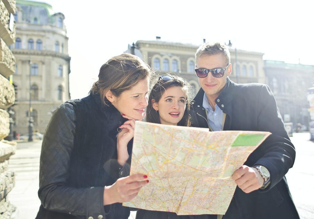 People Reading Map in the Middle of the Street