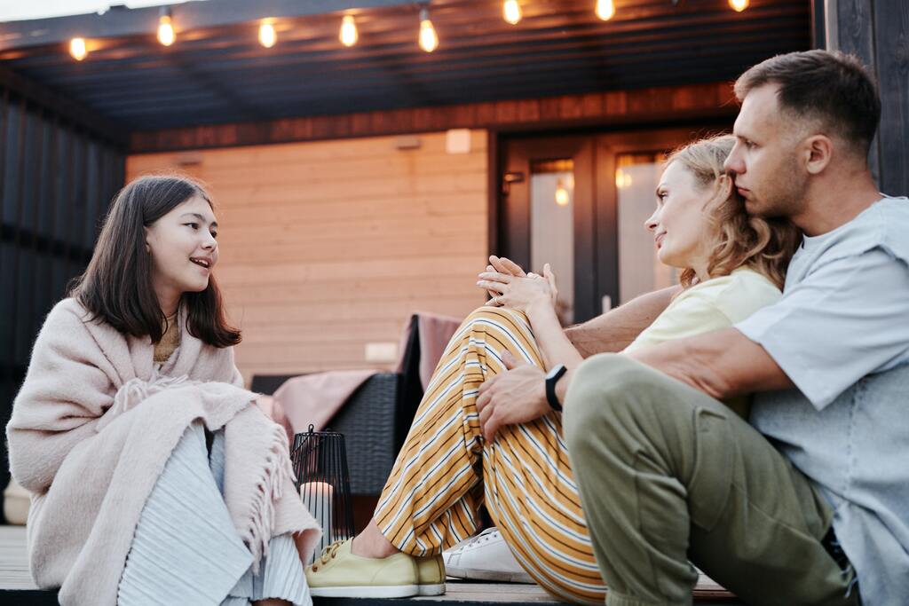 A girl having a conversation with her parents