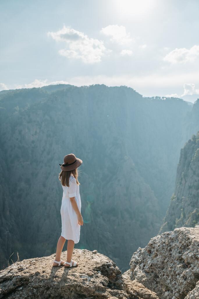 Woman in White Dress Standing on the Edge