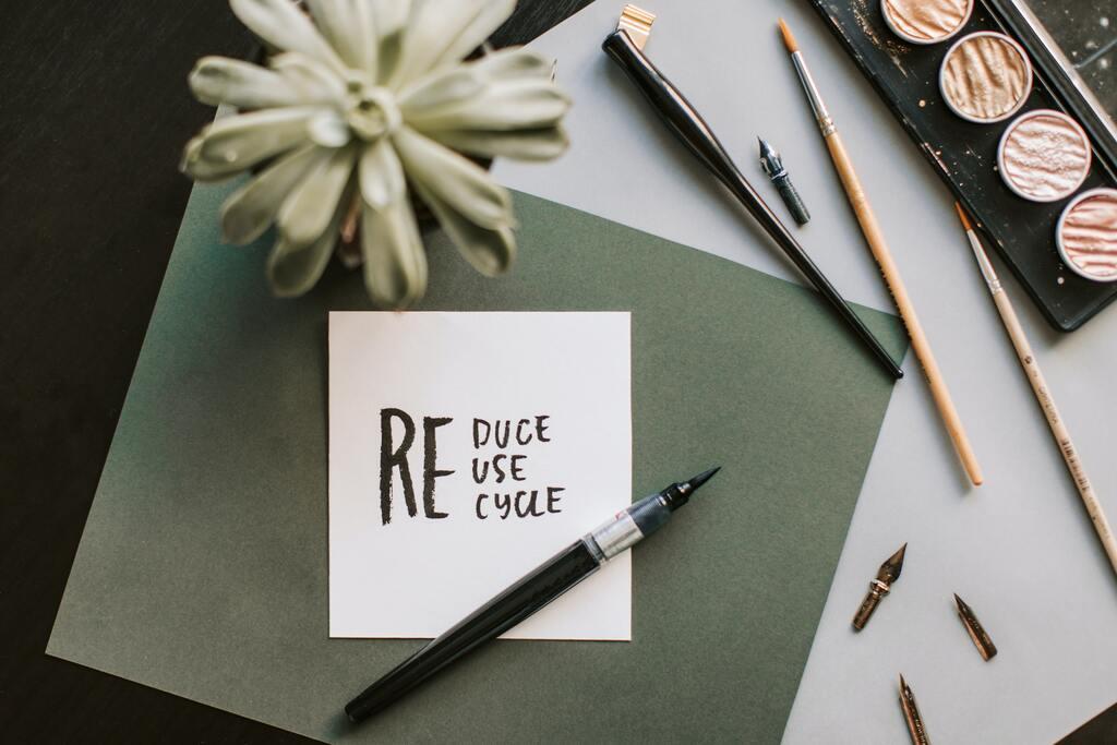 A paper with “Reduce, reuse, recycle” written on it
