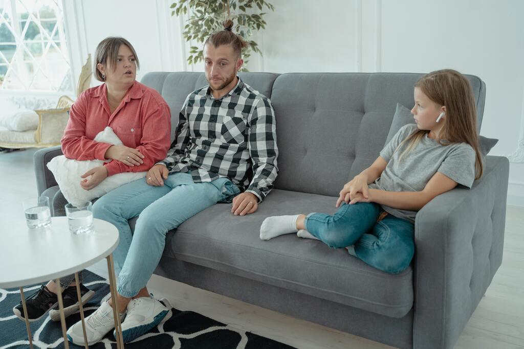 A Family Sitting on a Couch