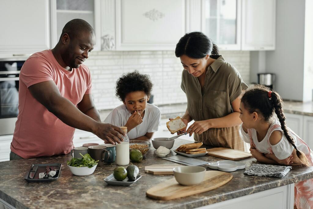 A family making breakfast together to promote sibling dynamics.