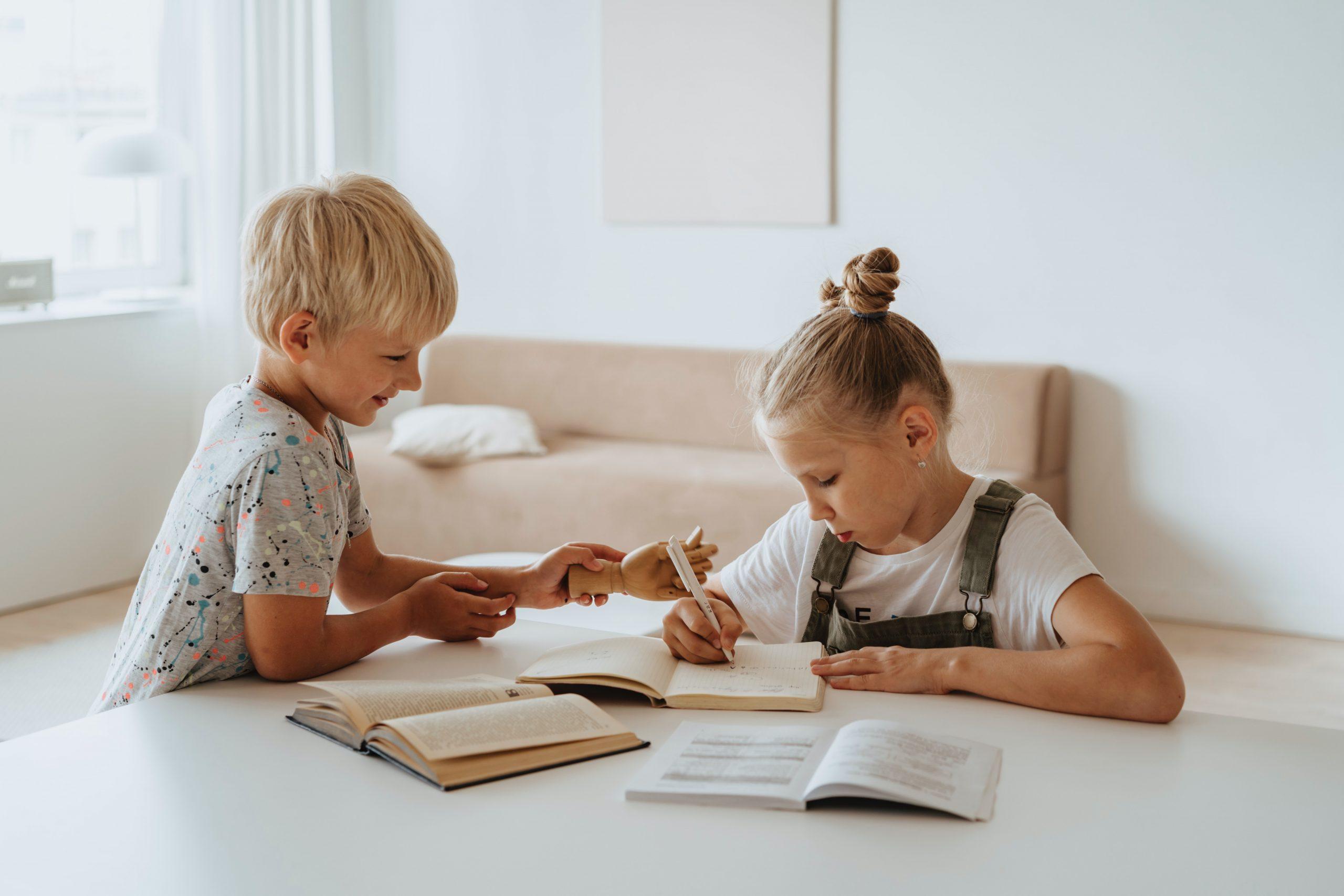 Two children drawing and talking.