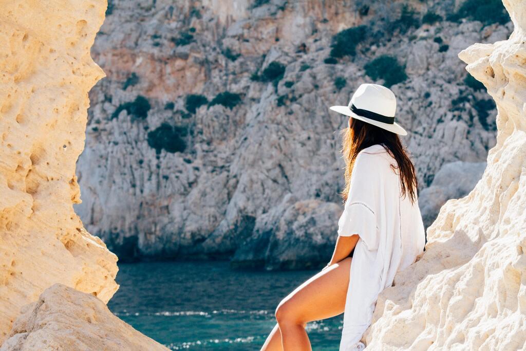 Rear View of Woman Sitting on a rock in Madrid, Spain.