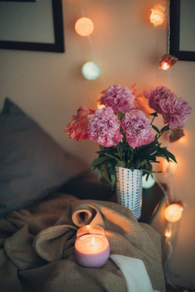 Candle and flowers on blanket