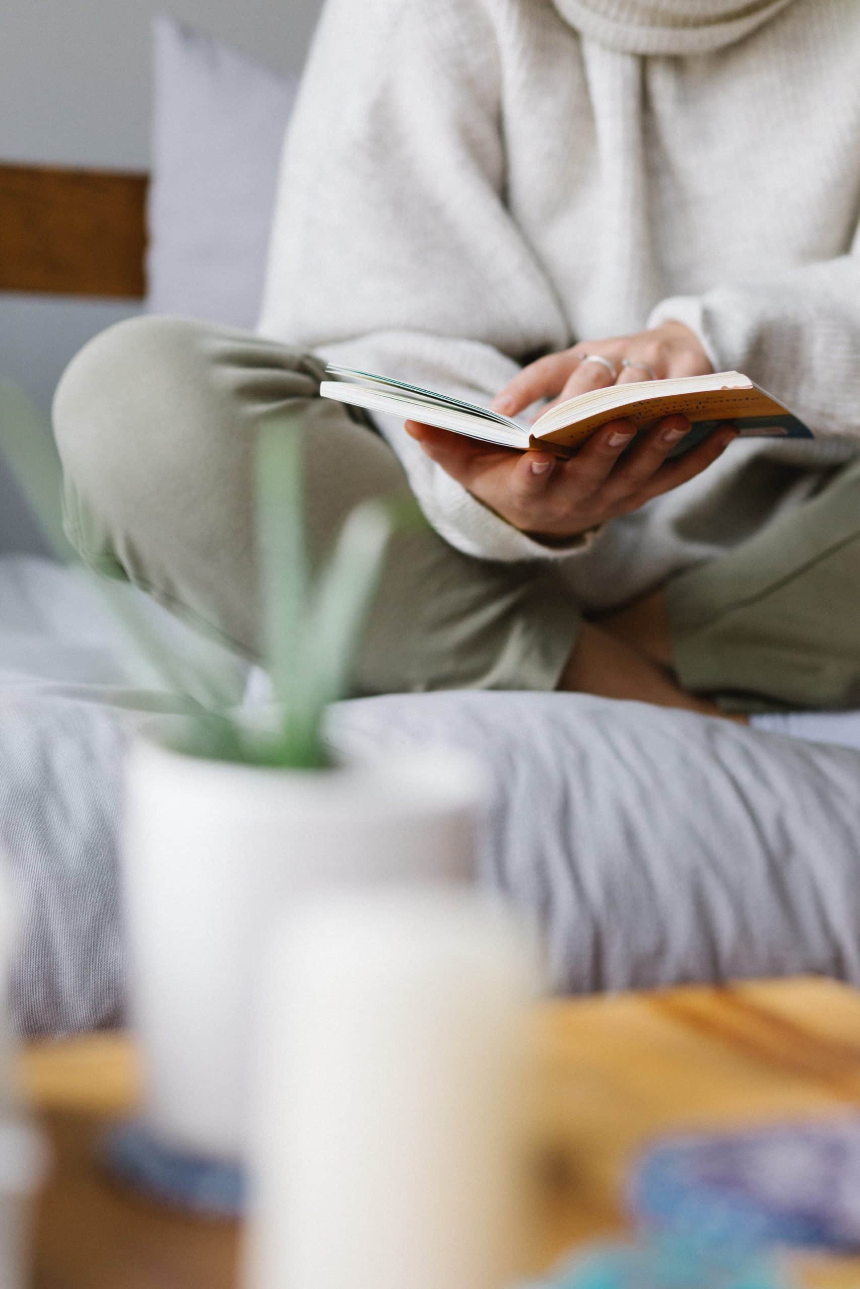 Lady sat crossed legged reading book
