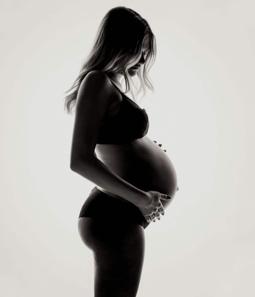 Pregnant woman cradling her bump