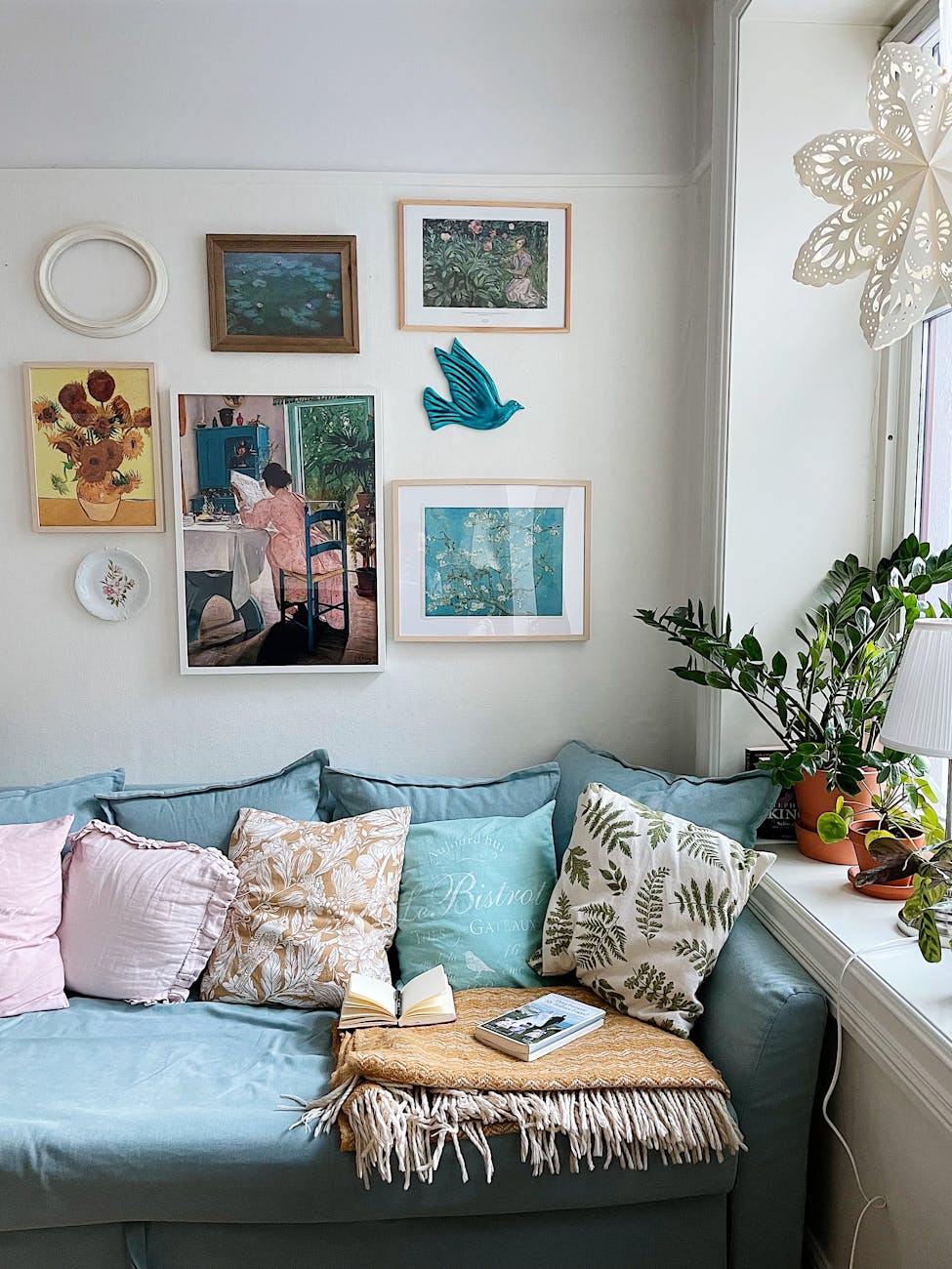sofa and paintings on a wall