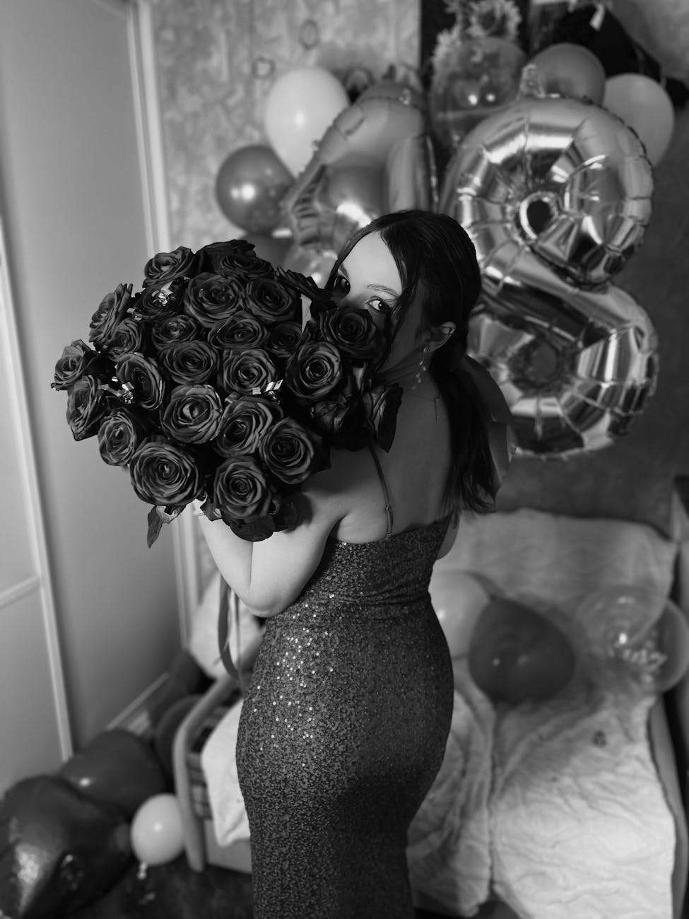 elegant woman celebrating with roses and balloons