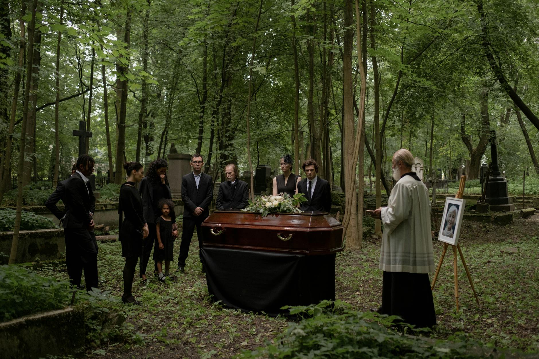 people mourning in graveyard