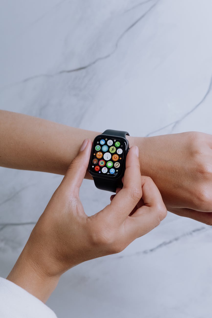 person wearing silver aluminum case apple watch with white sport band