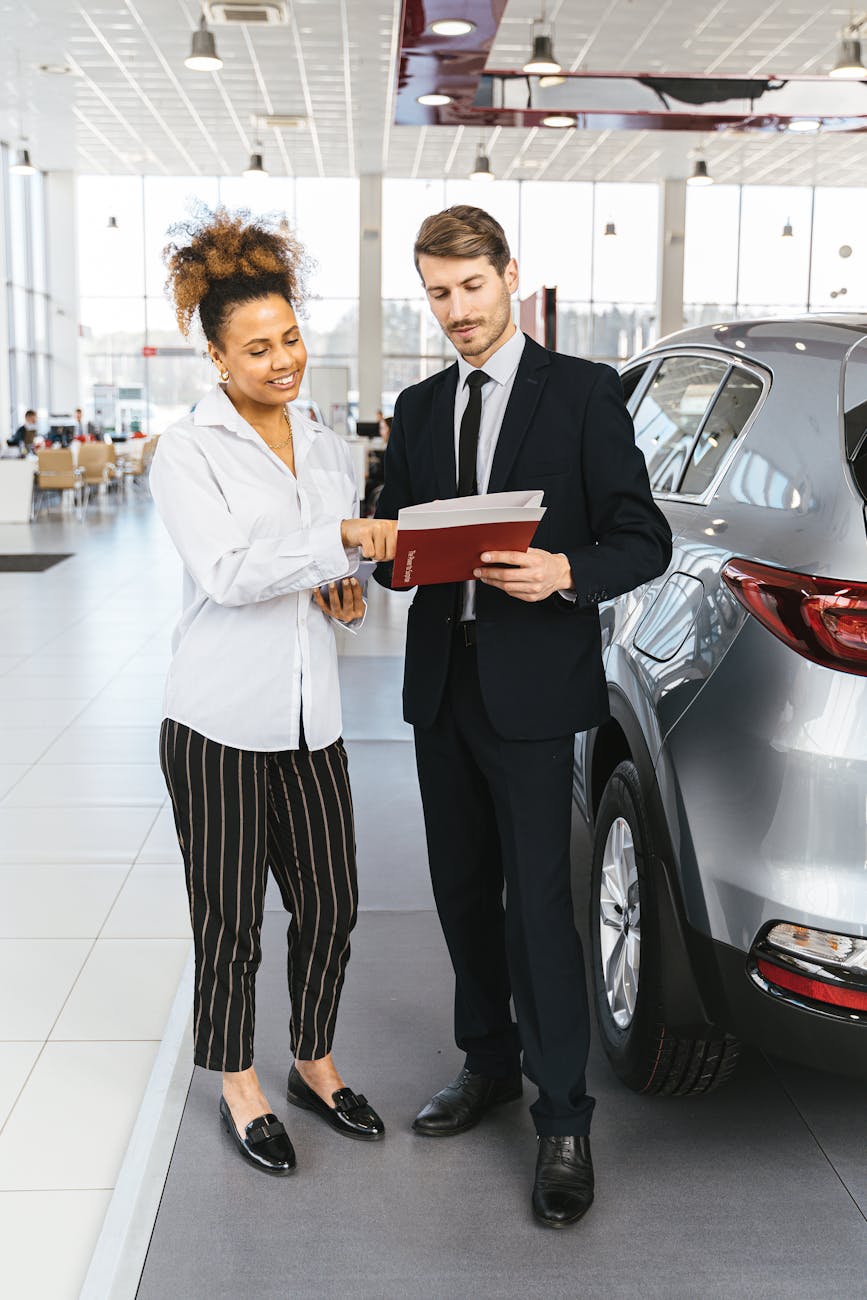 a woman talking to a car dealer