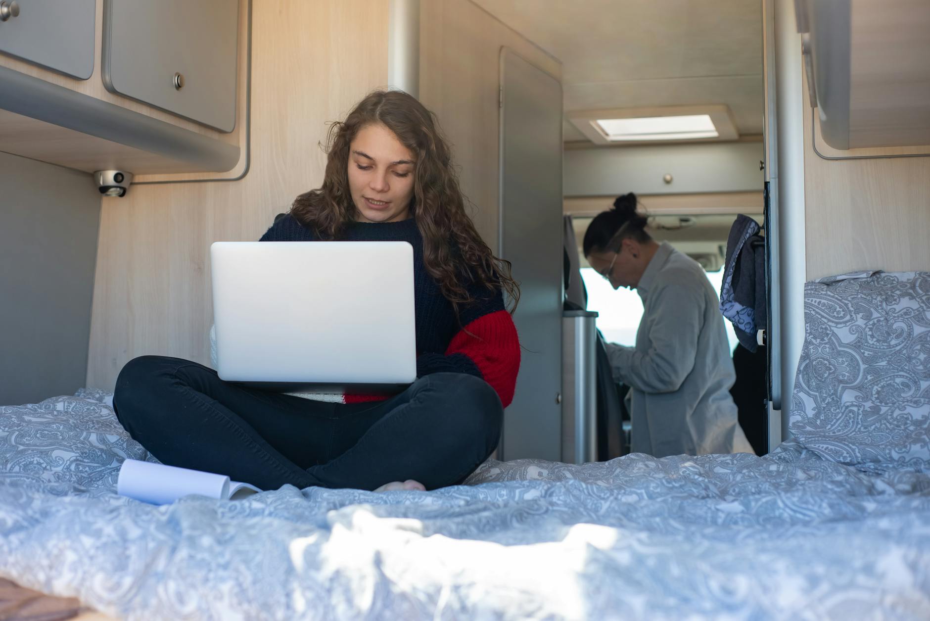 a woman using a laptop in an rv