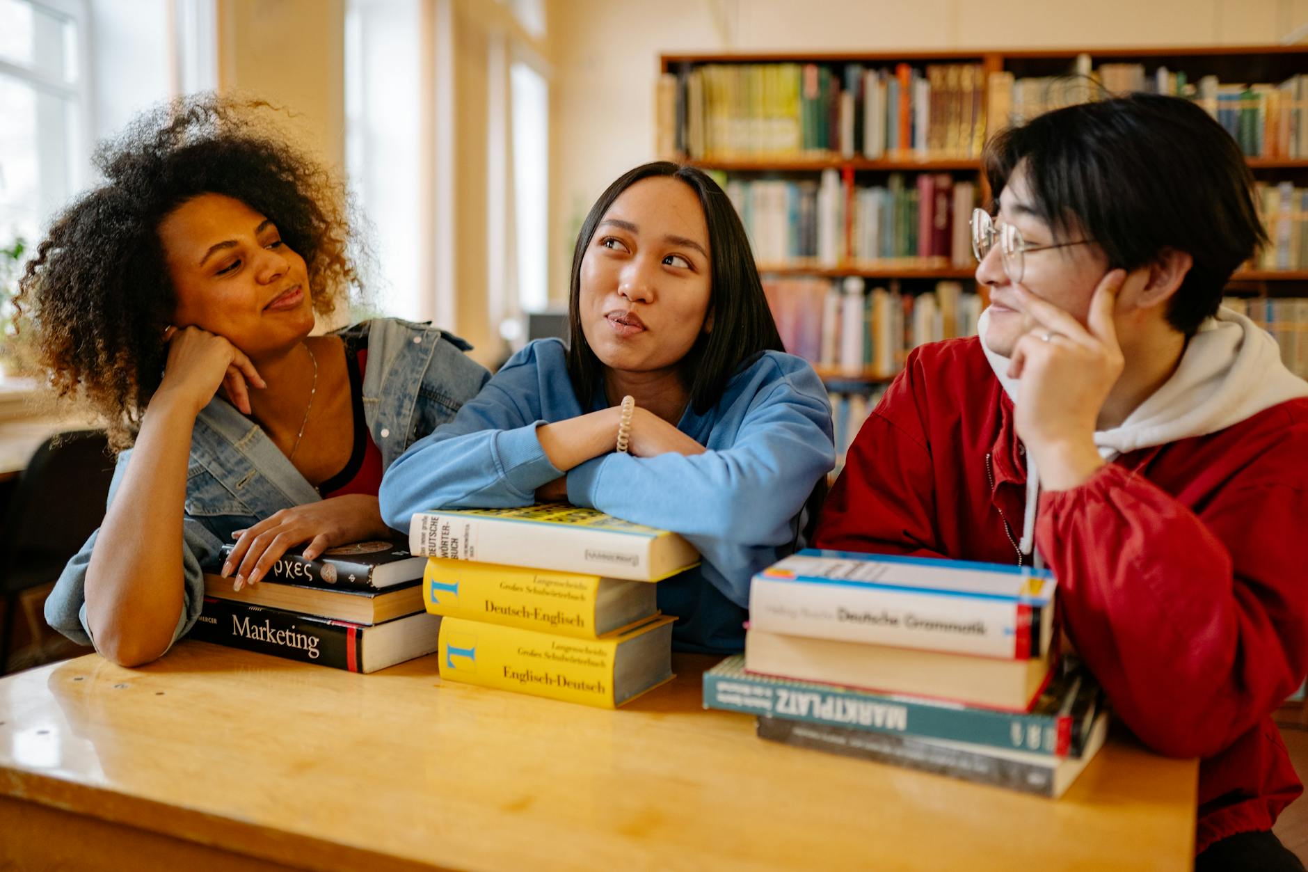 close up shot of three people in the library