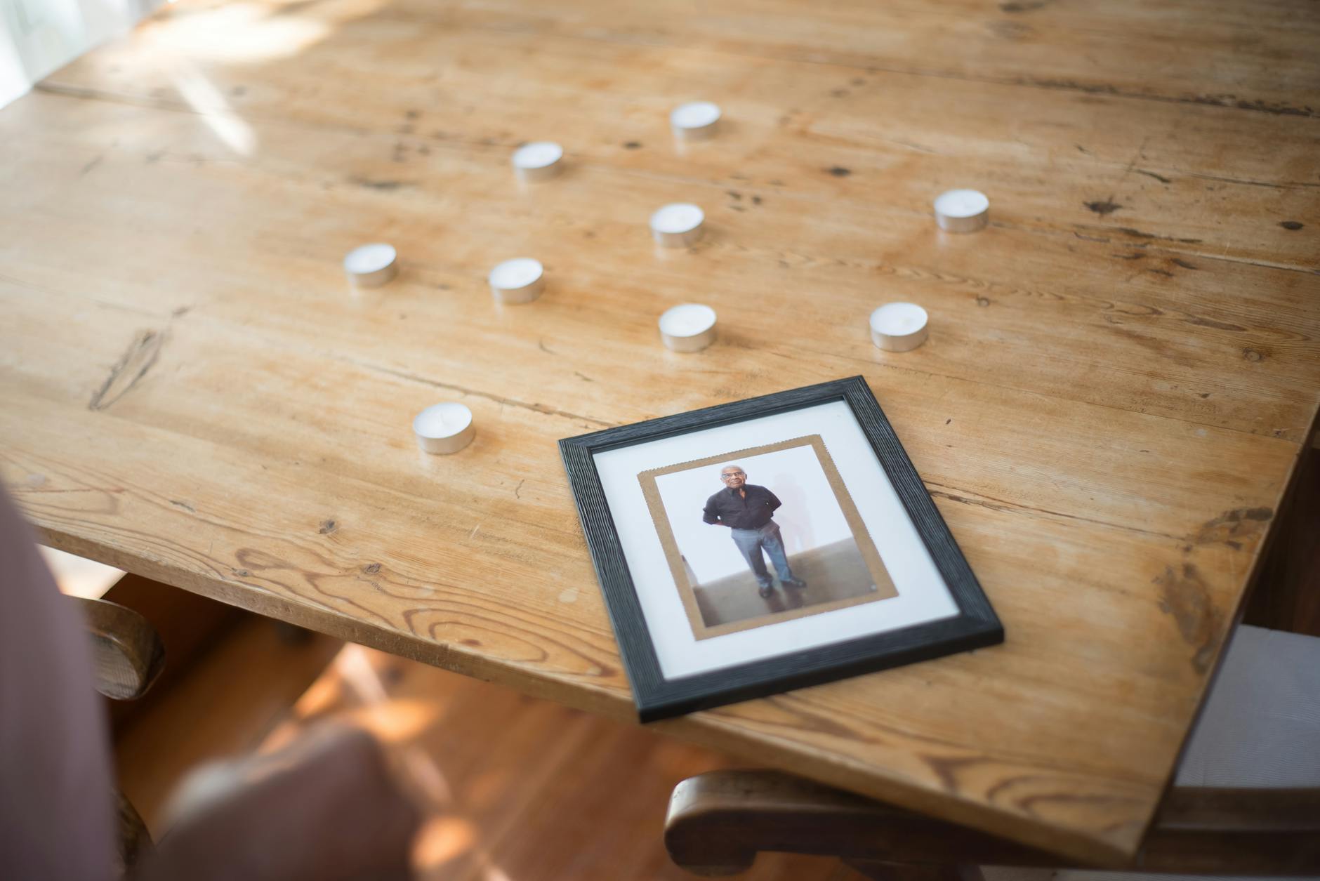 black wooden framed photo of man in black dress shirt