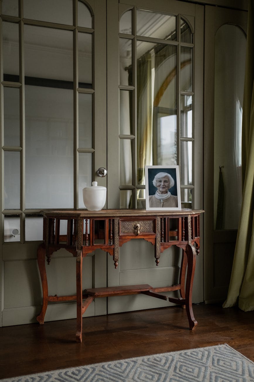 antique table with an urn and a portrait of the deceased