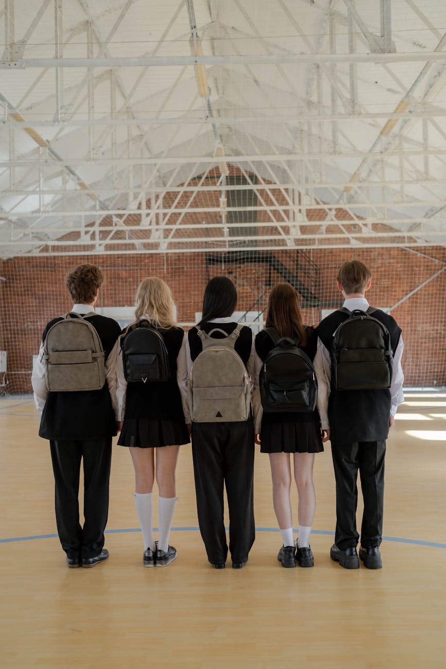 back view of a group of students wearing backpacks