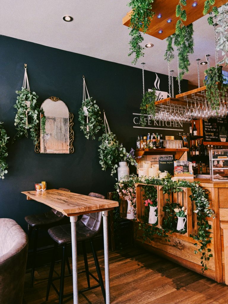 Charming Indoor Cafe with Greenery and Wooden Decor